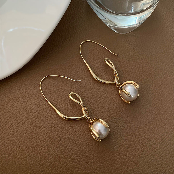 White pearl earrings with diamonds in gold